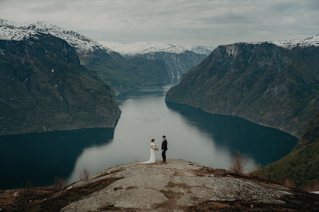 Couple reading their vows during their elopement overlooking the fjords in Norway
