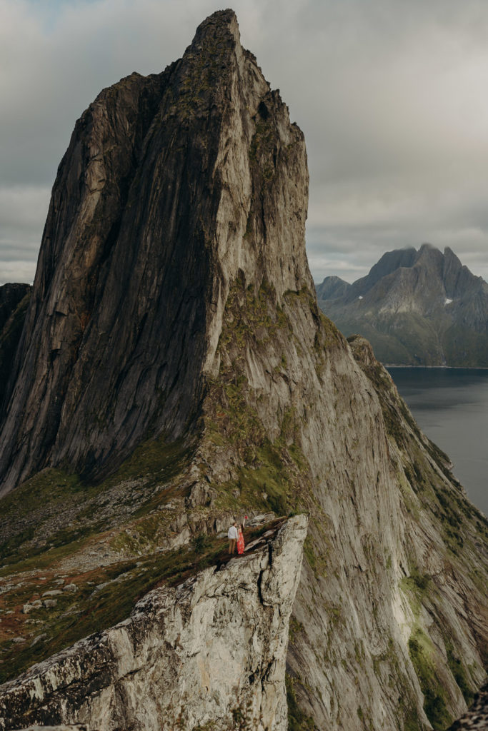 Couple embracing in stunning mountain landscape in senja norway