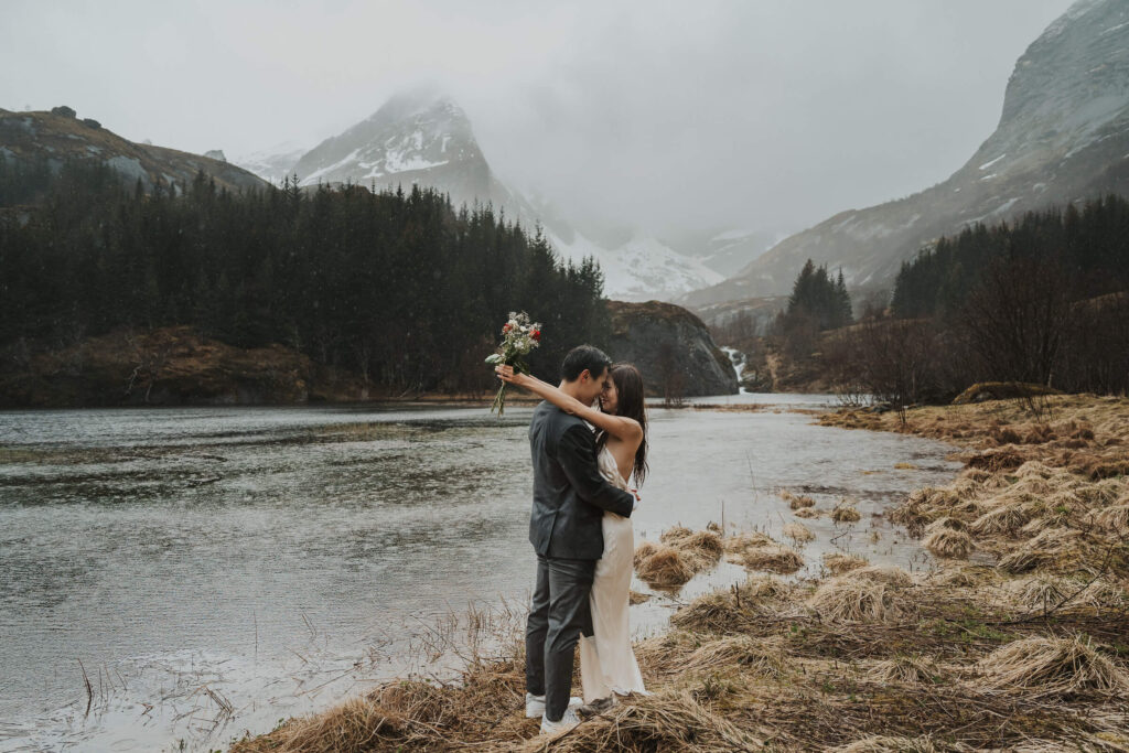 Elopement couple embracing in the rain in Lofoten
