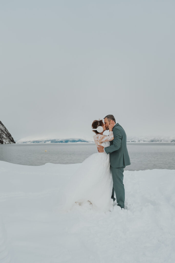 Wedding couple kissing in a winter landscape in Lyngen Norway