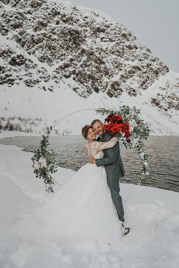 Couple exchanging vows in snowy mountains of Norway