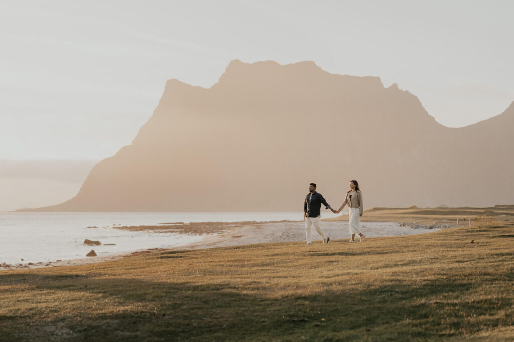 Couple walking in the sunset in Lofoten Norway